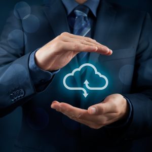 Cloud computing service concept - connect to cloud. Businessman offering cloud computing service represented by icon. Wide banner composition and bokeh in background.